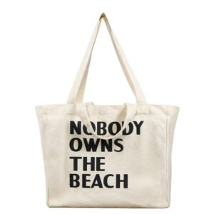 Ivory cotton tote bag with bold text print 'Nobody Owns The Beach', ideal for eco-conscious retail promotions or giveaways.