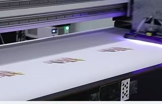 Digital UV printer printing colorful logos on white material