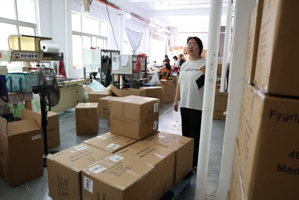 Packed cardboard boxes stacked in factory ready for canvas bag bulk shipment