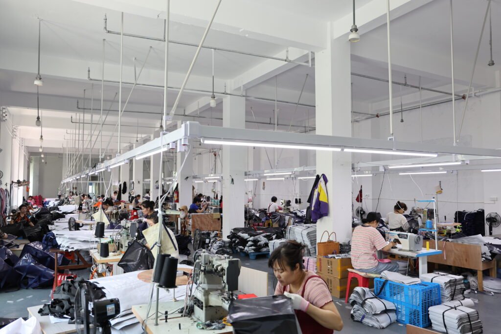 Wide sewing line with staff working on high-volume custom tote bag manufacturing