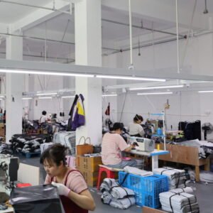 Wide sewing line with staff working on high-volume custom tote bag manufacturing
