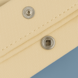 Close-up of reinforced metal rivet on eco-friendly canvas tote bag, ensuring strong handle attachment
