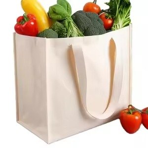 White reusable grocery tote bag filled with fresh vegetables, ideal for supermarket shopping, food storage, and eco-friendly packaging.