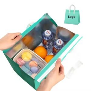 Green reusable insulated lunch tote bag with silver lining, containing water bottles, fruits, and a lunchbox, ideal for food storage and takeaway.