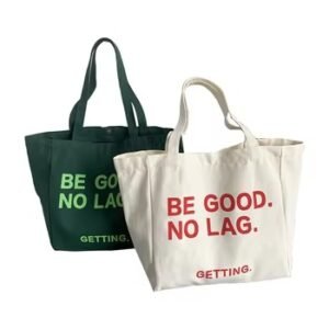 Set of green and white cotton tote bags with “BE GOOD. NO LAG.” slogan print, durable and eco-friendly for daily use