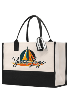 Eco-friendly black and white canvas tote bag featuring custom logo printing and decorative ribbon for branding promotions