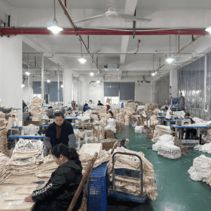 Bag factory interior with stacks of finished custom canvas tote bags ready for packaging and delivery