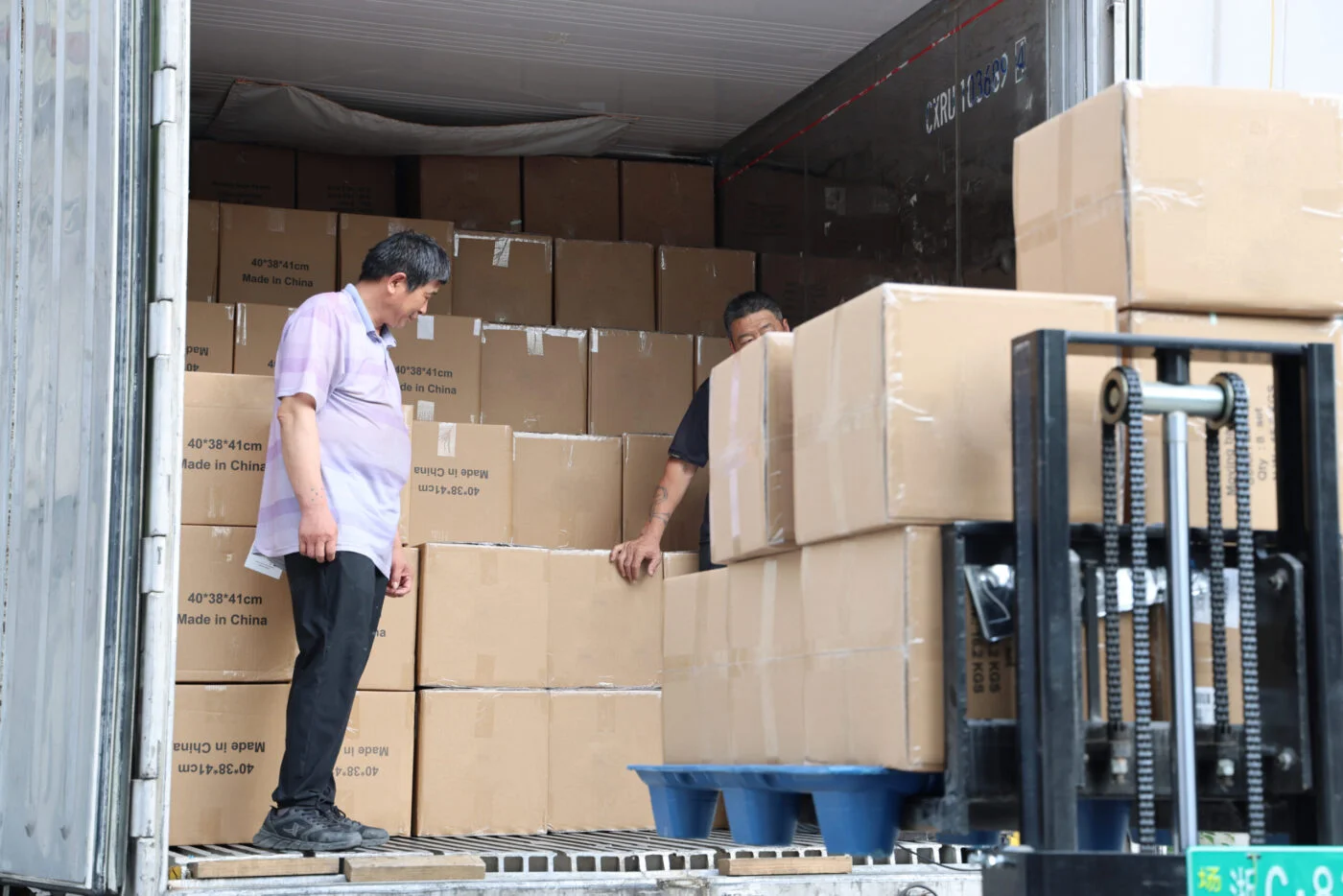 Workers loading components into anti-static totes for data center relocation