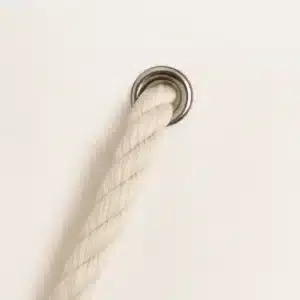 White cotton rope handle attached with a metal grommet on a tote bag