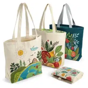 Set of custom printed reusable cotton shopping bags with colorful nature and fruit patterns.