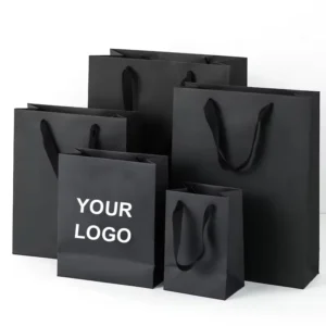 Set of black custom shopping bags with matte finish and printed logo, available in multiple sizes.
