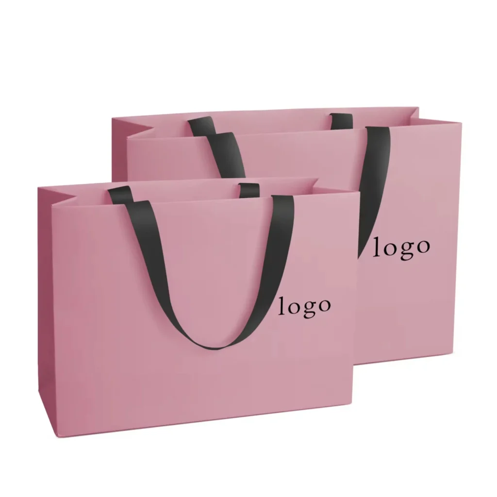 Pink custom logo paper shopping bags with black handles for retail packaging