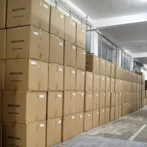 Storage area with large stacked cardboard boxes filled with wholesale custom canvas tote bags