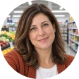 Avatar Alt Moving Bags Manufacturing Tiiocti Representative Retail Buyer In An Orange Cardigan Under Cool Supermarket Ceiling Lights Not An Actual Customer Photo