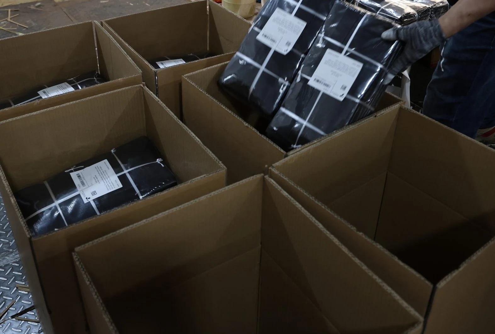 Labeled bag bundles packed in shipping cartons at TIIOCTI
