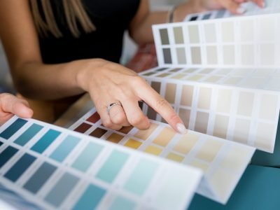 Close-up,Of,Two,Women,Choosing,Samples,Of,Wall,Paint.,Interior
