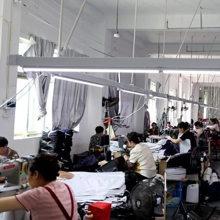 Bright sewing workshop where tailors are assembling high-quality custom canvas tote bags