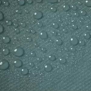 Water-resistant fabric surface with visible water droplets on storage bag material