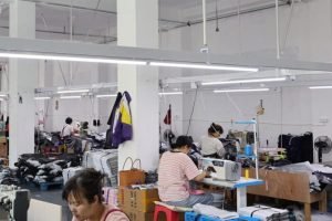 Wide sewing line with staff working on high-volume custom tote bag manufacturing