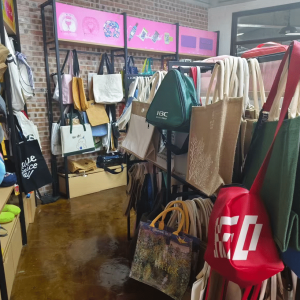 Display of various reusable shopping bags in a retail or showroom environment
