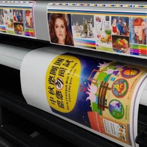 Large format printer printing colorful poster with Chinese text Digital printing machine producing colorful custom designs on fabric sheets, ideal for personalized tote bag and textile printing