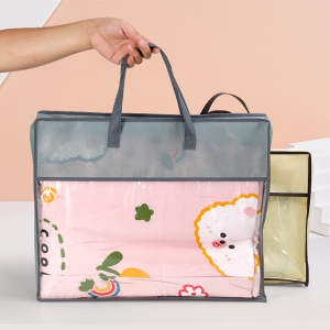 Gray reusable storage tote bag with transparent front, carrying a folded blanket, ideal for home organization, travel storage, and packing solutions.
