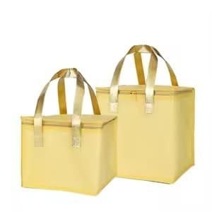 Set of two yellow reusable insulated lunch tote bags with gold handles, ideal for food delivery, grocery shopping, and thermal preservation.