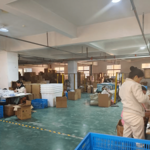 Worker inspecting and packing jute drawstring bags during quality control process