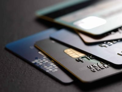 stack of multicolored credit cards on black background